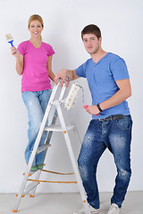 Image showing happy couple paint wall at new home