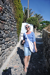 Image showing Greek woman on the streets of Oia, Santorini, Greece