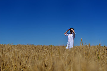 Image showing young woman in wheat field at summer