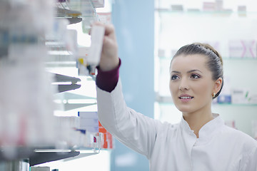 Image showing pharmacist chemist woman standing in pharmacy drugstore