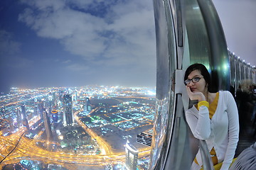 Image showing beautiful woman portrait with big city at night in background