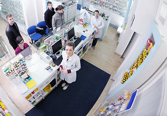 Image showing pharmacist suggesting medical drug to buyer in pharmacy drugstor