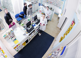 Image showing pharmacist suggesting medical drug to buyer in pharmacy drugstor