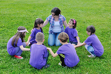 Image showing happy kids group with teacher in nature