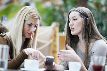 Image showing cute smiling women drinking a coffee
