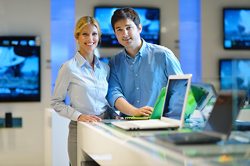 Image showing Young couple in consumer electronics store