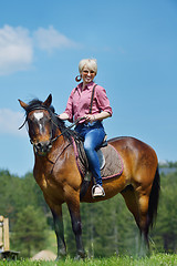 Image showing happy woman  ride  horse