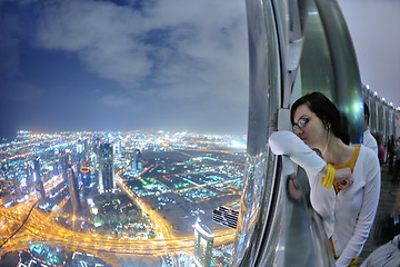 Image showing beautiful woman portrait with big city at night in background