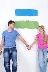 Image showing happy couple paint wall at new home