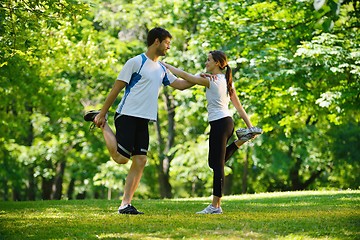 Image showing Couple doing stretching exercise  after jogging