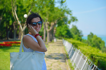 Image showing young business woman using mobile phone outdoor