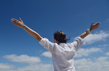 Image showing happy young woman with spreading arms to sky