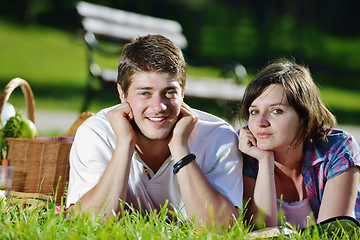 Image showing happy young couple having a picnic outdoor