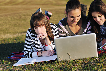 Image showing group of teens working on laptop outdoor