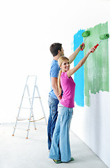 Image showing happy couple paint wall at new home