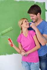 Image showing happy couple paint wall at new home