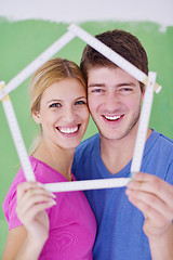 Image showing happy couple paint wall at new home