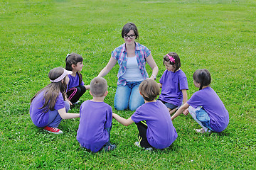 Image showing happy kids group with teacher in nature