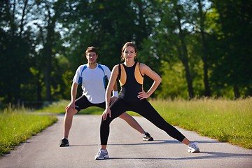 Image showing Couple doing stretching exercise  after jogging