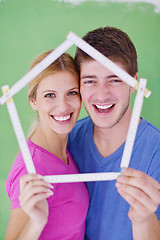 Image showing happy couple paint wall at new home