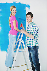 Image showing happy couple paint wall at new home