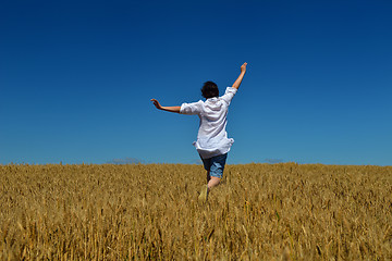 Image showing young woman in wheat field at summer