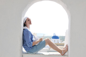 Image showing Greek woman on the streets of Oia, Santorini, Greece