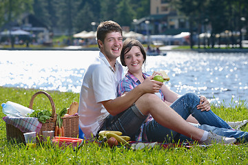 Image showing happy young couple having a picnic outdoor