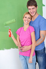 Image showing happy couple paint wall at new home