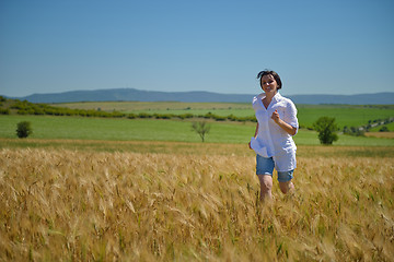 Image showing young woman in wheat field at summer