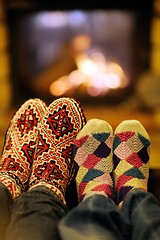Image showing Young romantic couple relax on sofa in front of fireplace at hom