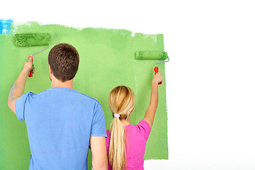 Image showing happy couple paint wall at new home