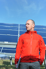 Image showing engineer using laptop at solar panels plant field