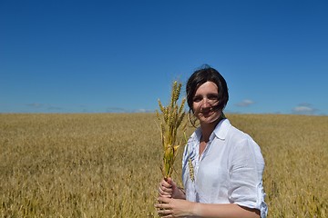 Image showing young woman in wheat field at summer