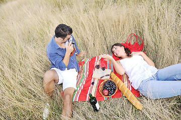 Image showing happy couple enjoying countryside picnic in long grass