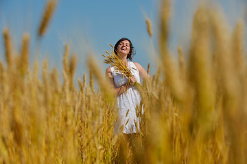 Image showing young woman in wheat field at summer