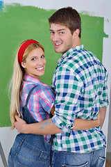 Image showing happy couple paint wall at new home