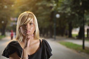 Image showing brunette Cute young woman  posing outdoors