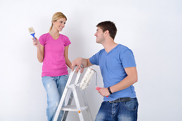 Image showing happy couple paint wall at new home