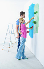 Image showing happy couple paint wall at new home