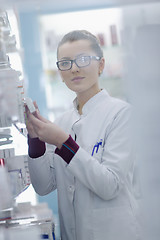 Image showing pharmacist chemist woman standing in pharmacy drugstore