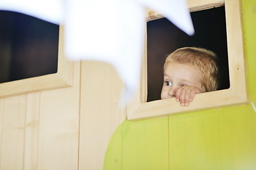 Image showing happy child in a window