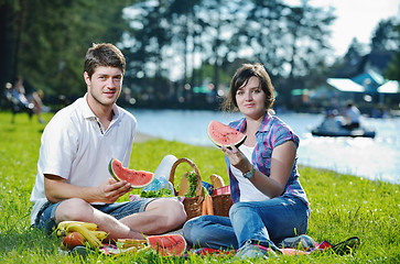 Image showing happy young couple having a picnic outdoor