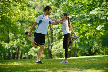 Image showing Couple doing stretching exercise  after jogging