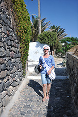 Image showing Greek woman on the streets of Oia, Santorini, Greece