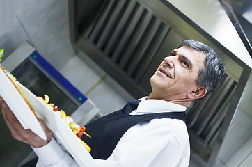 Image showing male chef presenting food