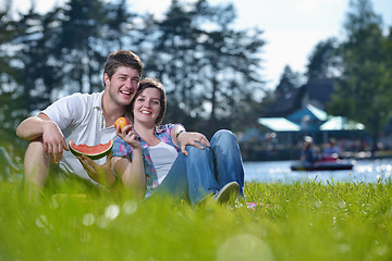 Image showing happy young couple having a picnic outdoor