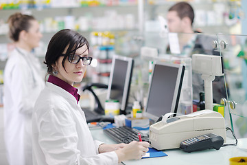 Image showing pharmacist suggesting medical drug to buyer in pharmacy drugstor