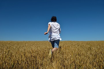 Image showing young woman in wheat field at summer