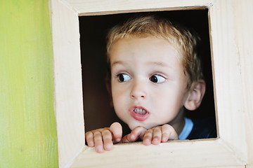 Image showing happy child in a window